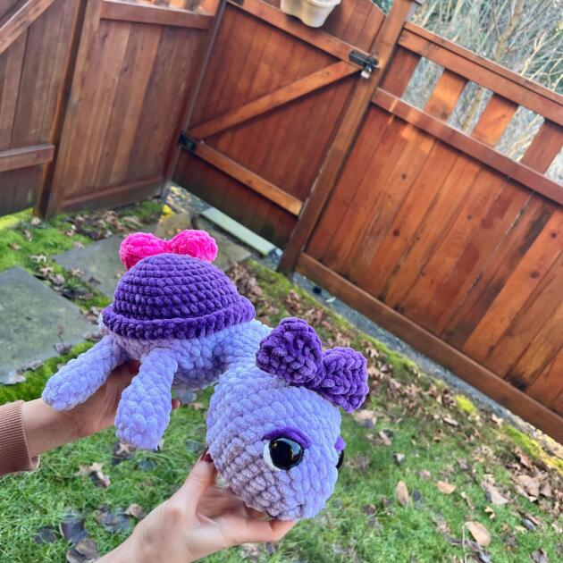 Handmade crochet heart turtle holding a bright red heart