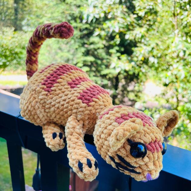 Adorable amigurumi cat stuffed toy in gray color on display